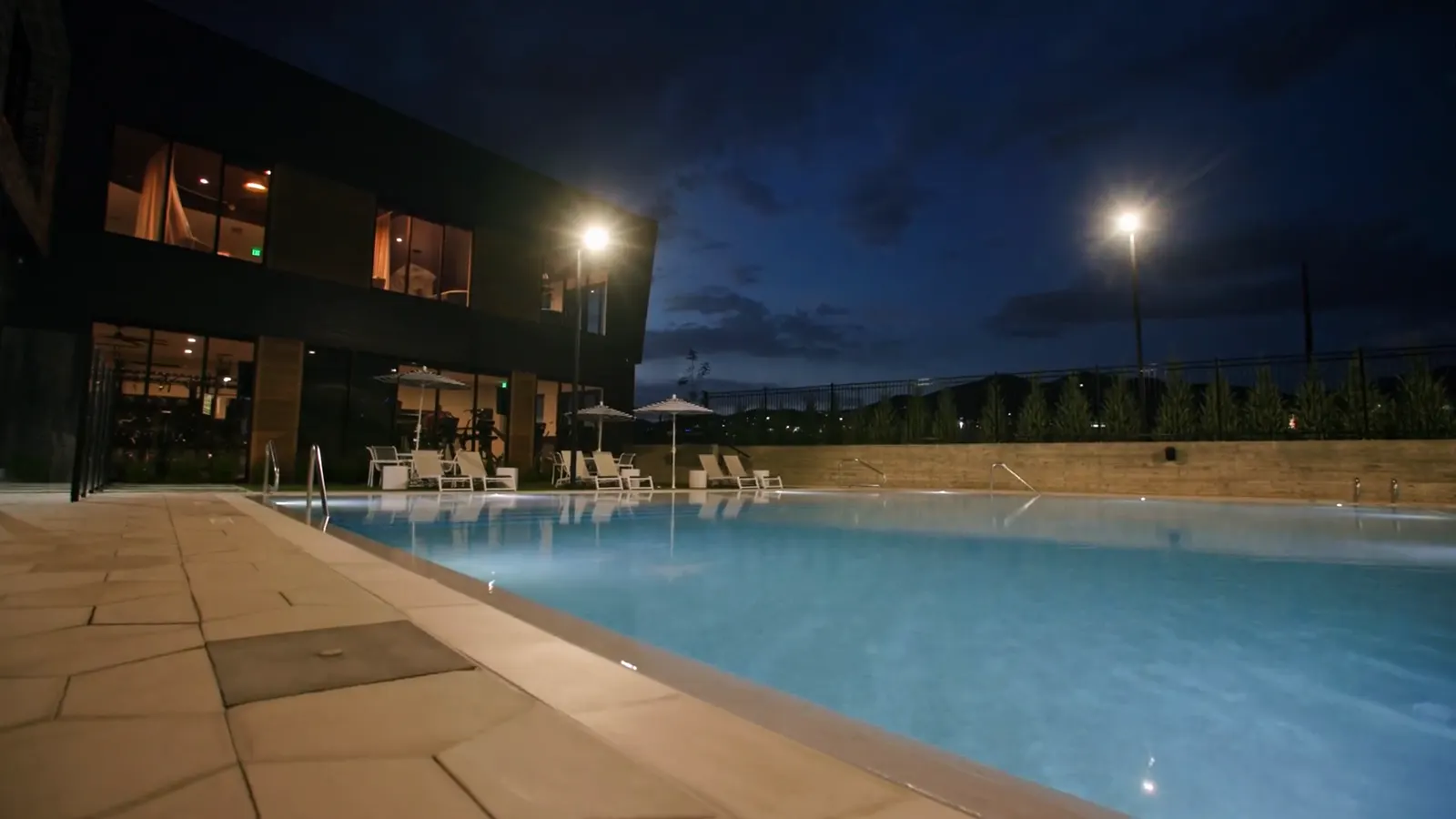 The Embold pool deck lit at night
