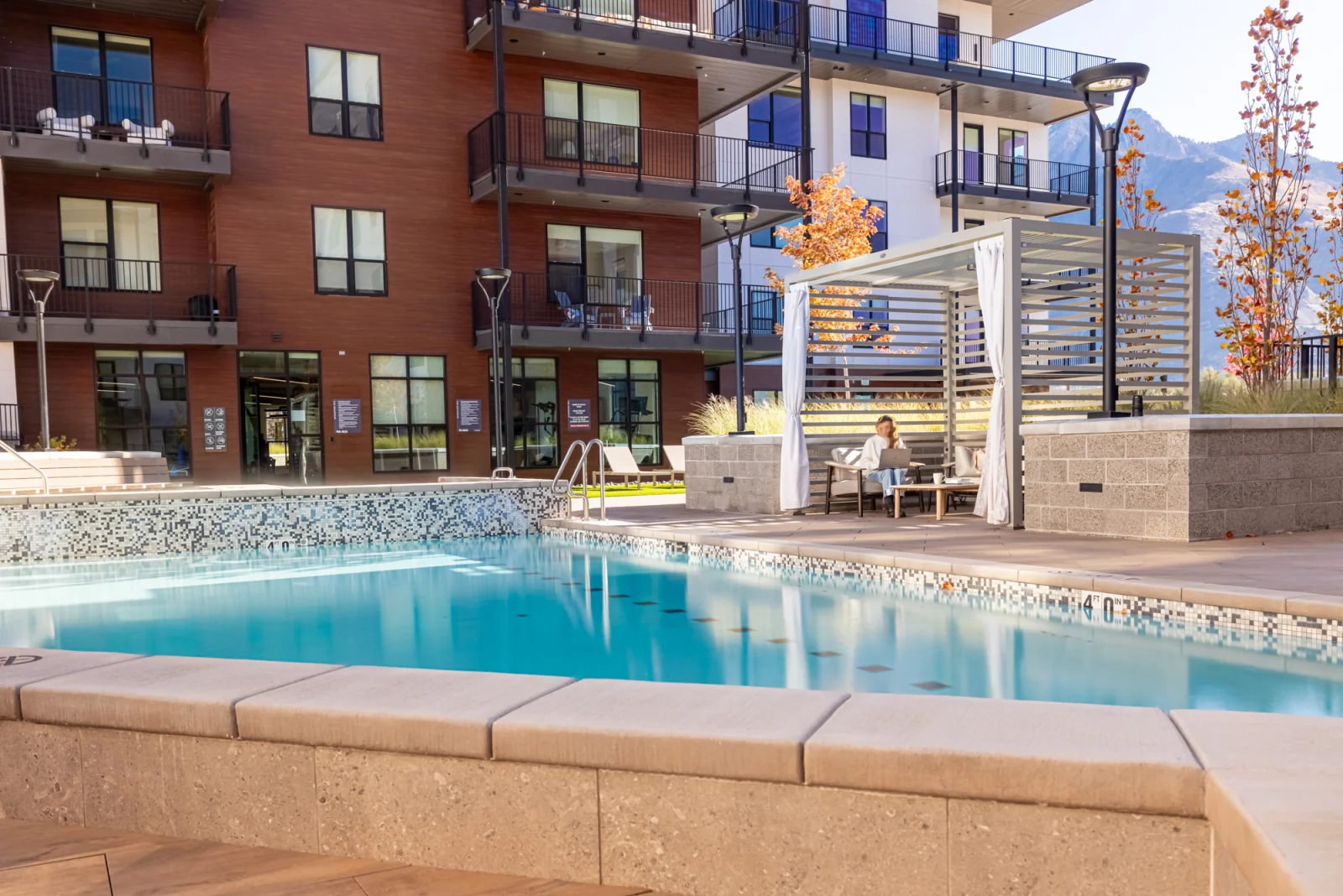 The Grandeur pool and cabana terrace in daylight, Mount Olympus beyond