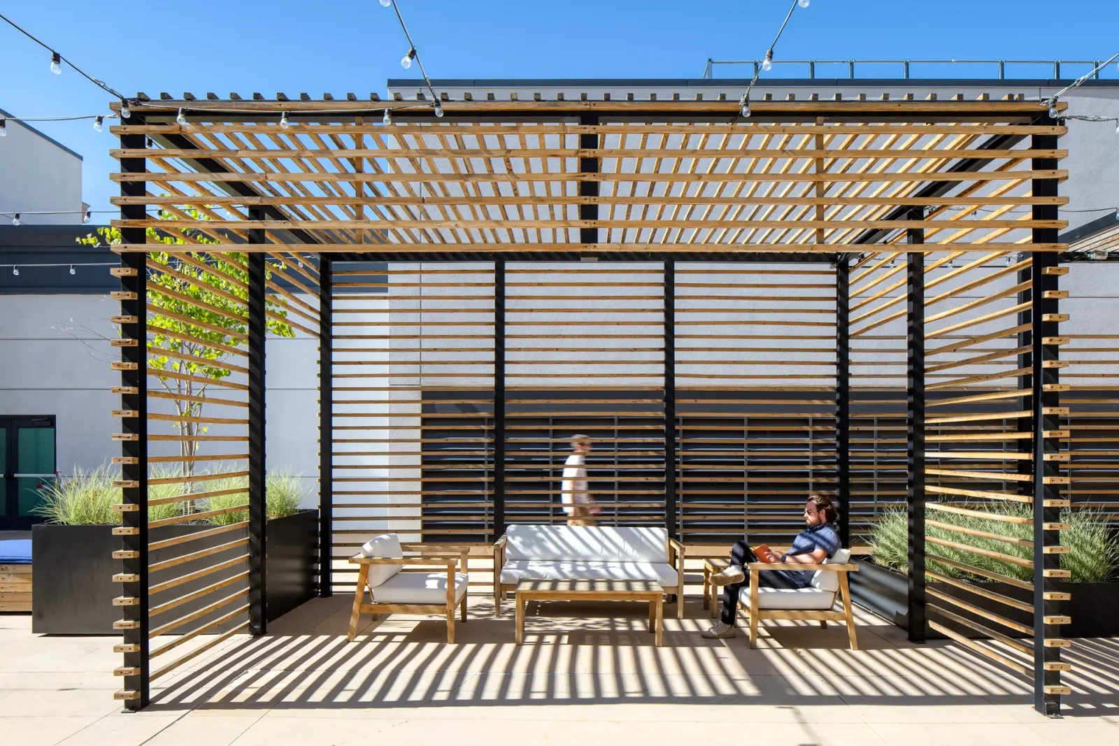 Hidden Gem rooftop pergola lounge with the downtown towers behind