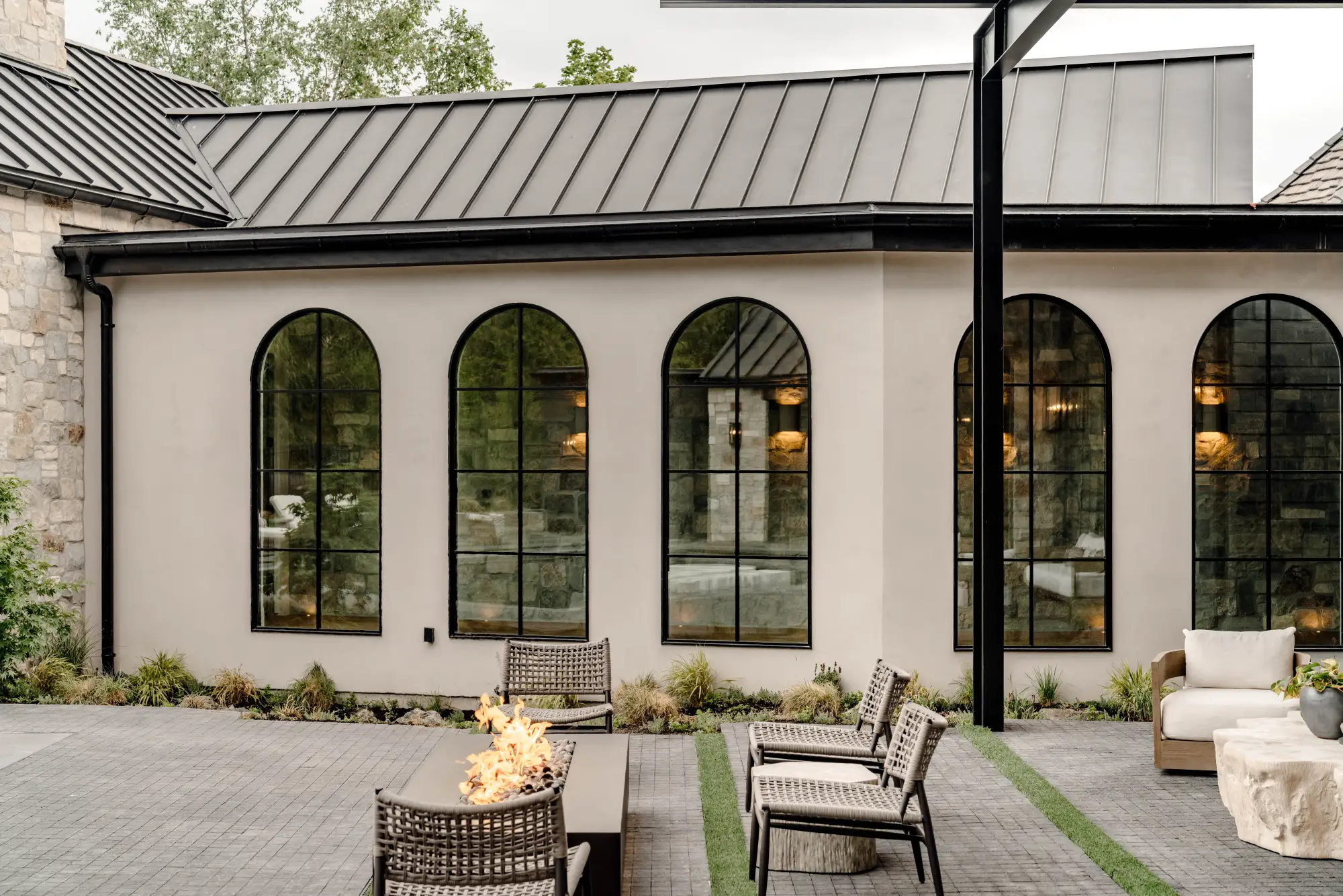 The long arched stucco wing above the fire court at dusk