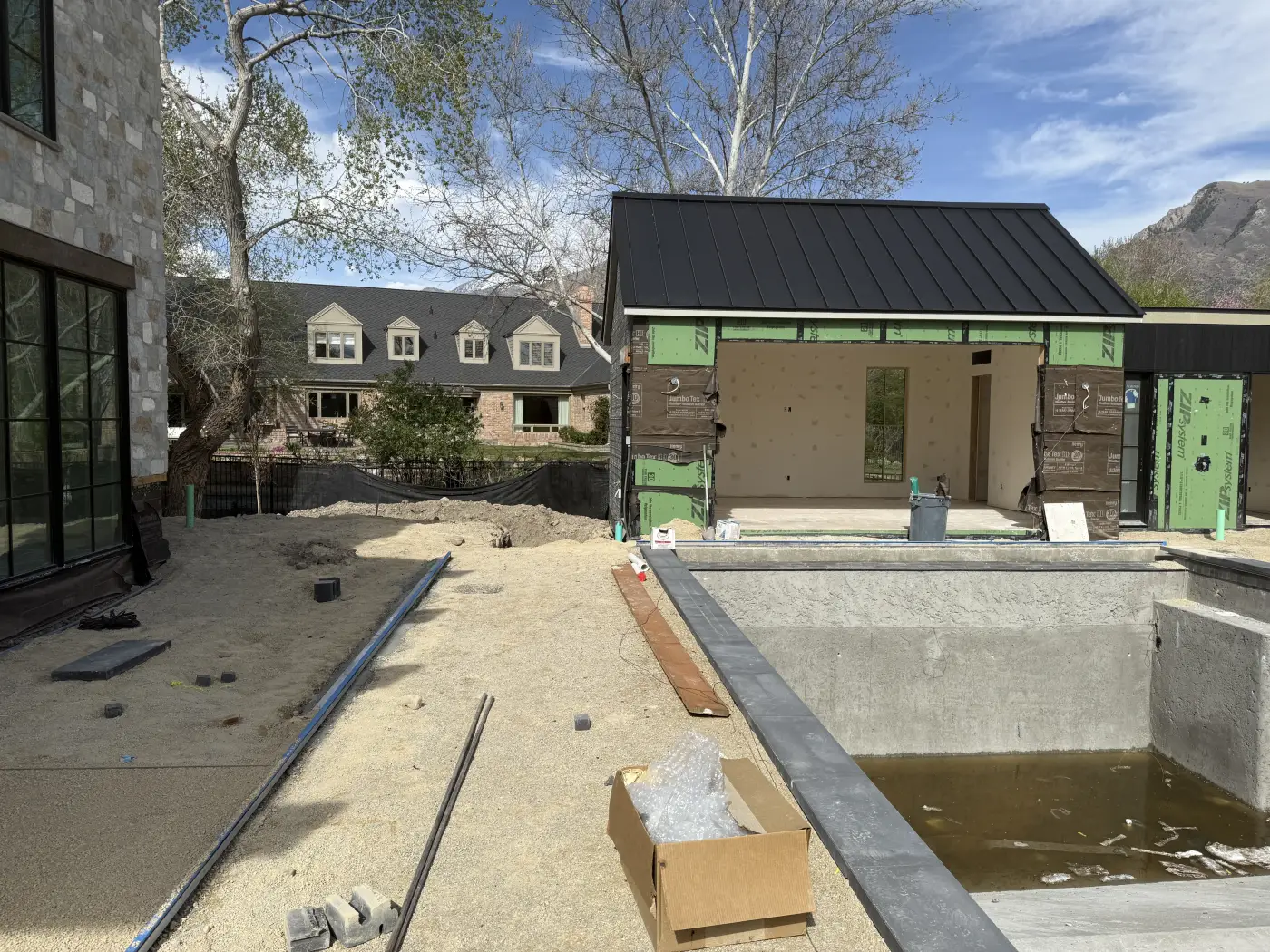 The pool, before · a concrete shell and standing water