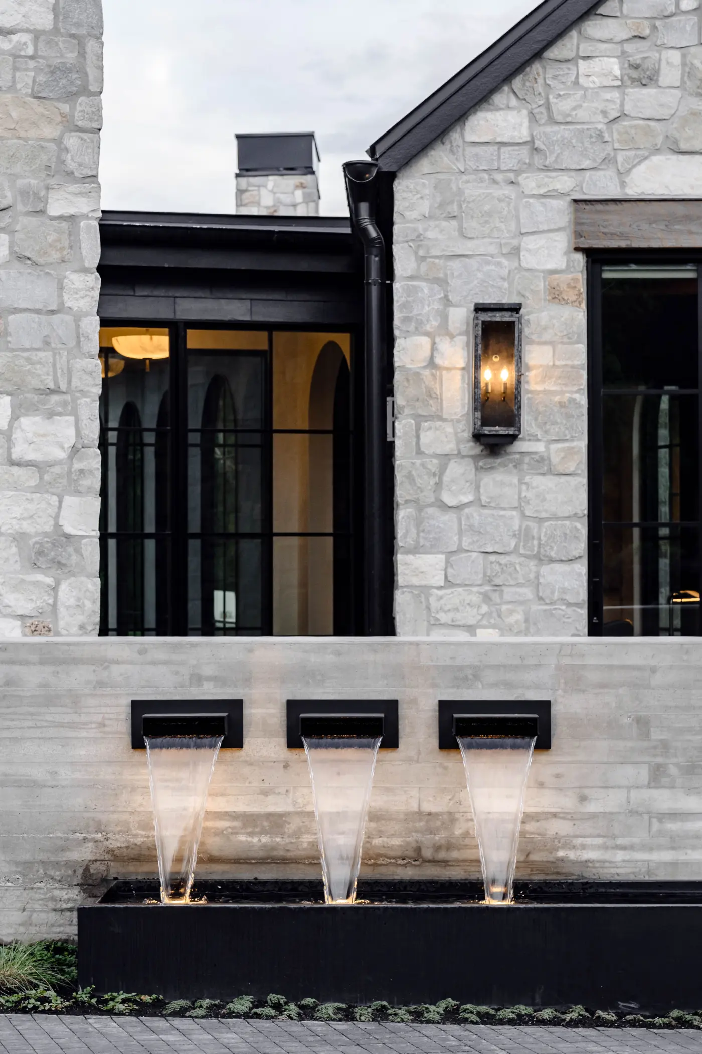 The entry · three scuppers into a black trough