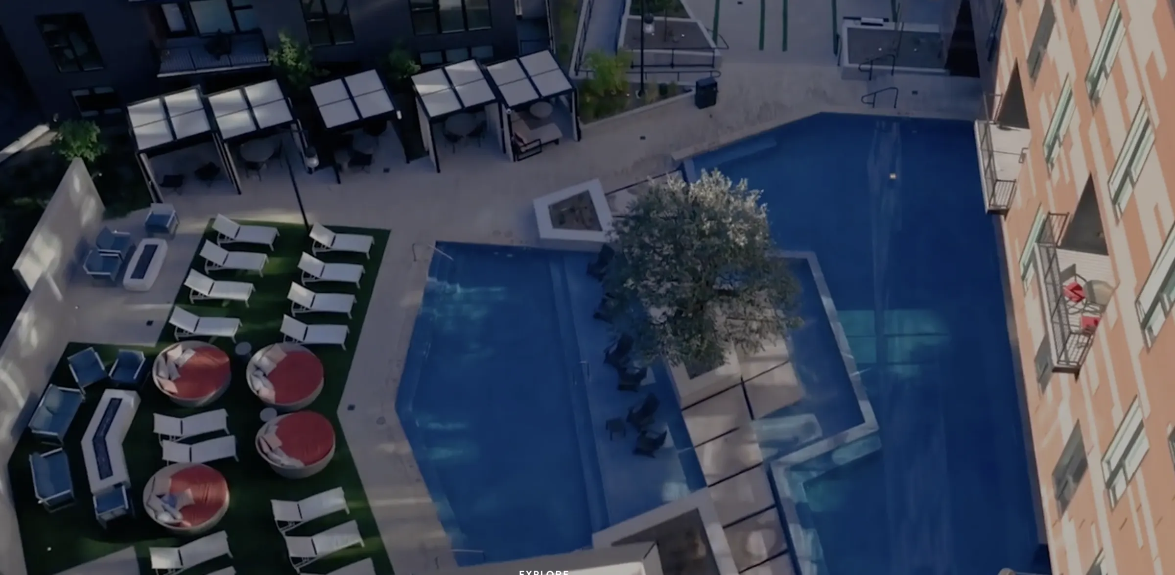 Post House pool courtyard from above, cabanas and lounges around the year-round pool