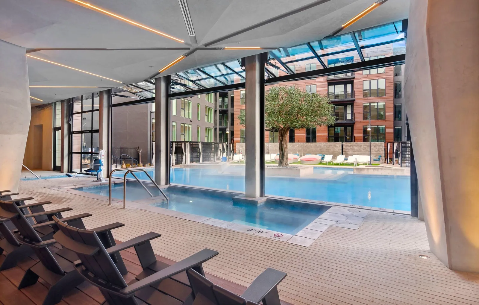 Inside the pool canopy: the year-round pool with the hinged doors open to the courtyard