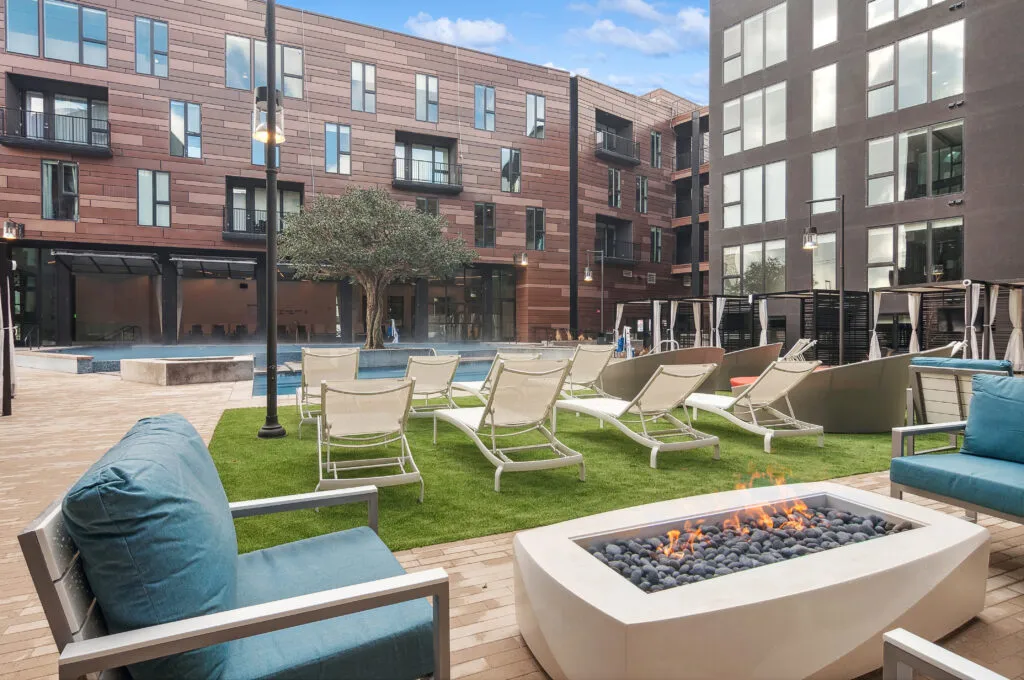 The pool deck: loungers, lawn and the firepit