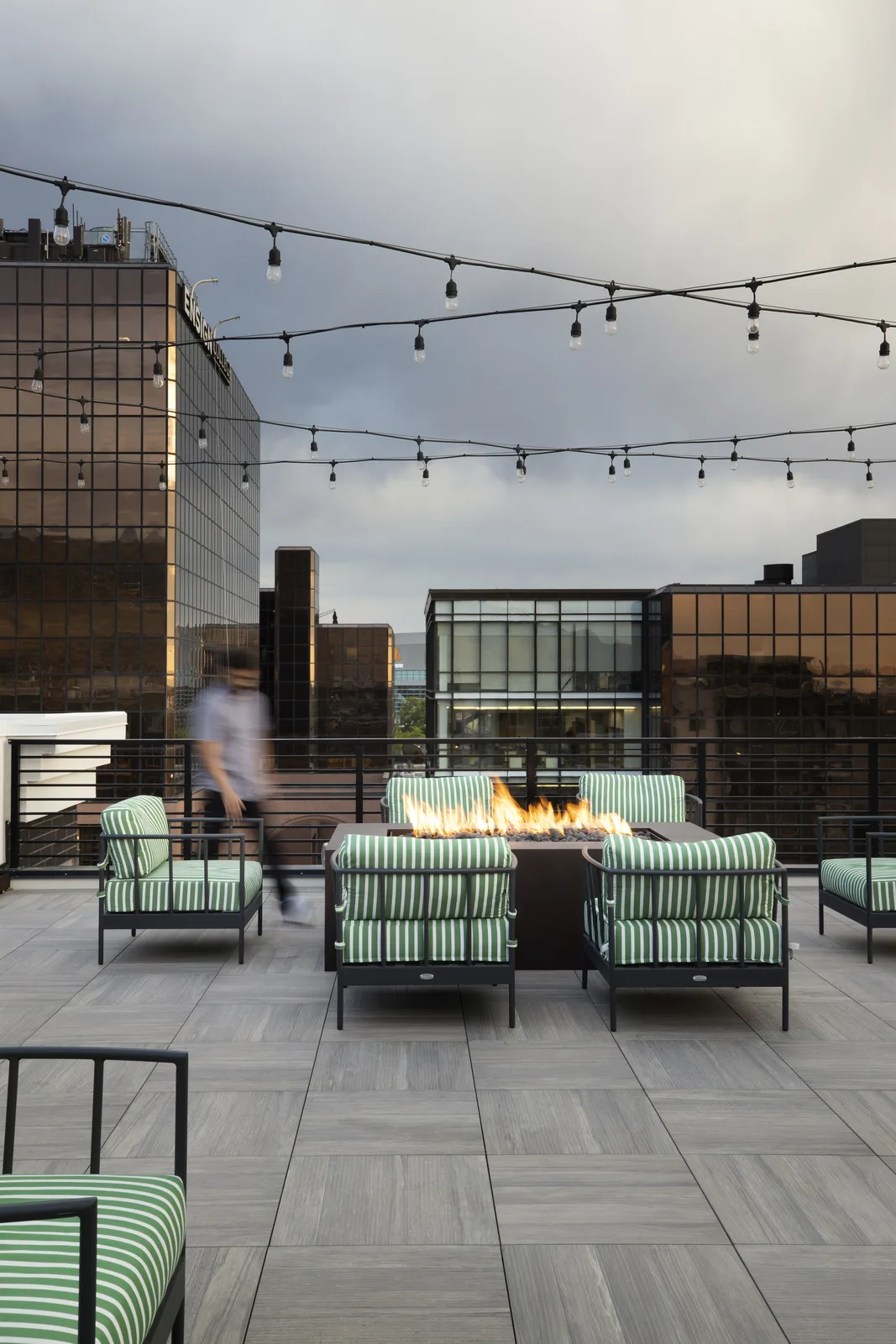 Rooftop fire pit with the downtown skyline at twilight