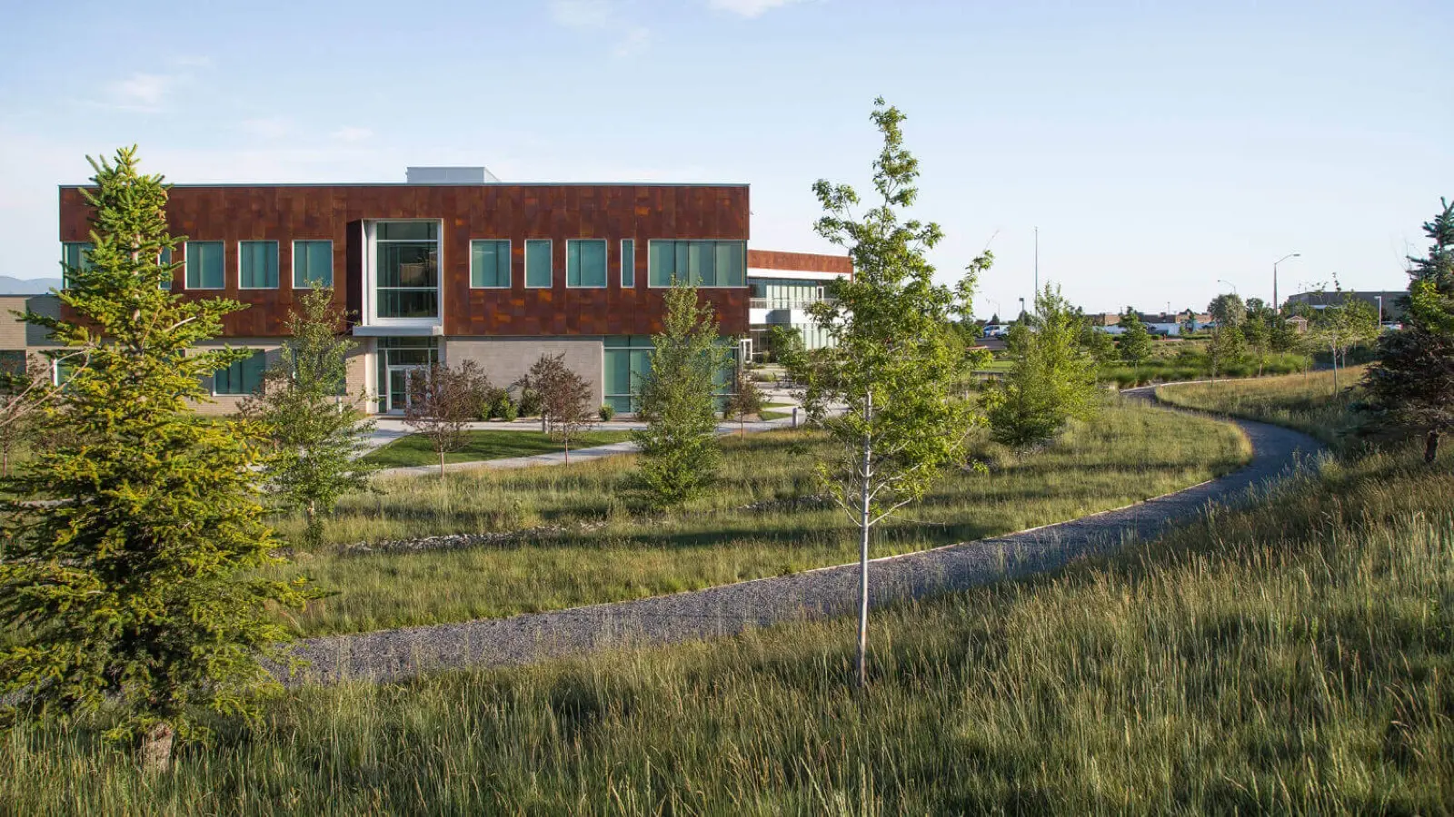 Tooele Tech campus building with the native meadow and path in front